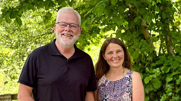 Councillors Peter and Vikki stood in front of greenery