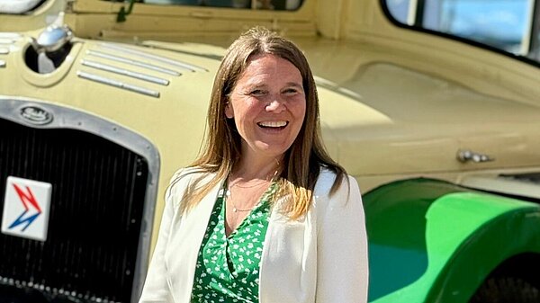 Vikki stood in front of a bus