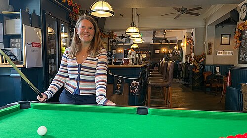 Vikki stood at a pool table in a local pub