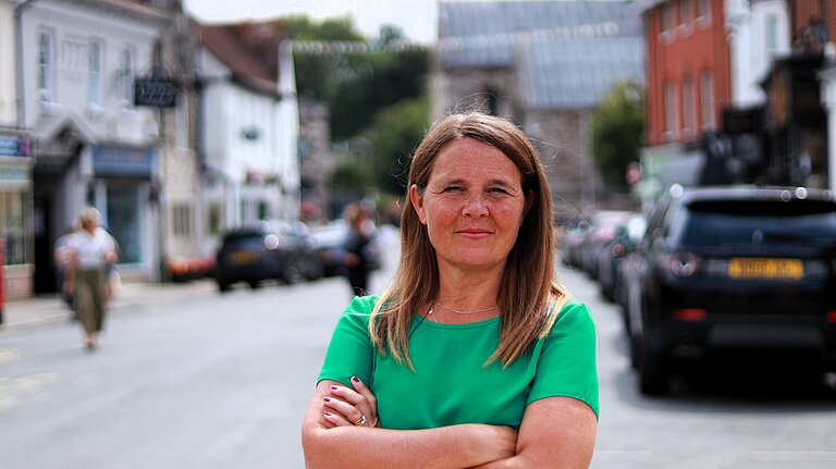 Vikki stood in Wimborne High street with her arms folded