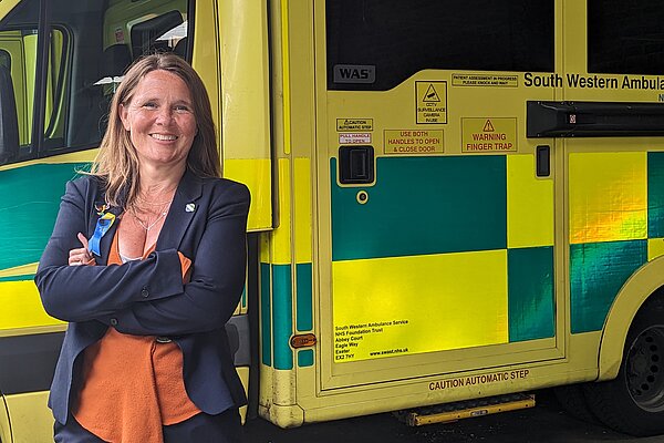Vikki Slade MP stood in front of an ambulance