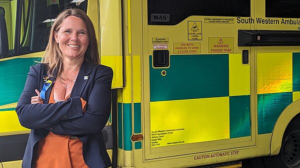 Vikki stood in front of an ambulance