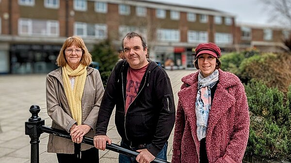 Councillors Sandra, Chris and Clare of Canford Heath Ward stood in front of a stair railing